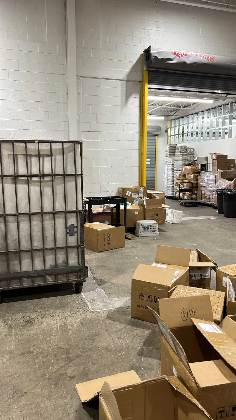 Dock-height receiving door with roll cage and hand truck